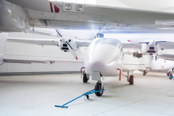 istock High-winged twin-engined light airplanes in hangar 1173923582