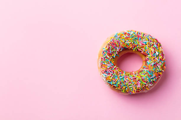 istock Donut on pink background. Top view. Copy space. 1173924354