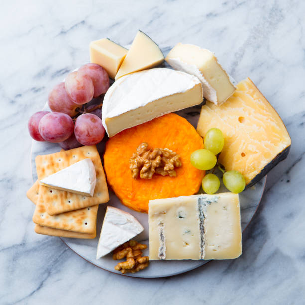 istock Assortment of cheese, grapes and crackers. Marble background. Top view. 1173925422