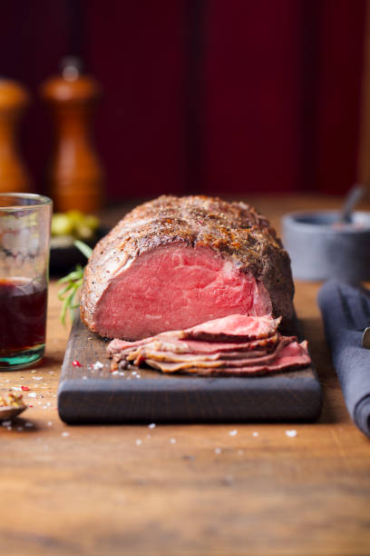 istock Roast beef on cutting board. Wooden background. Copy space. 1173928078