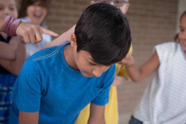 istock Kid gets bullied and pointed at 1173930435