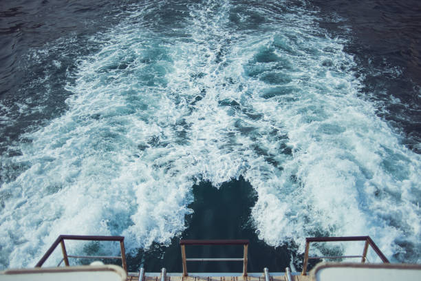 istock White waves behind a sailing ship on the sea 1173931911
