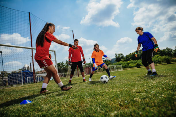istock Teens in action - playing soccer and practicing penalty kicks for goalkeepers 1173932562