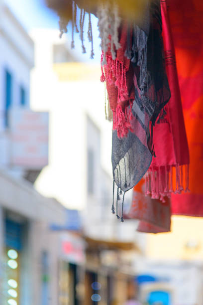 Colorful clothing fabrics and sarongs at Ubud market, hung for the cutomers to browse through.
