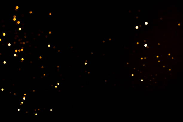 Golden abstract bokeh on black background. Holiday concept