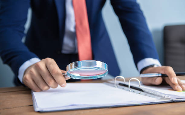 istock businessman looking with a magnifier 1173938910