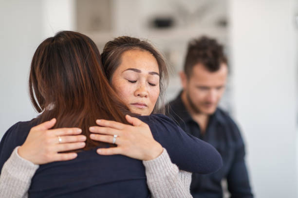istock Two women hug in therapy session 1173939224