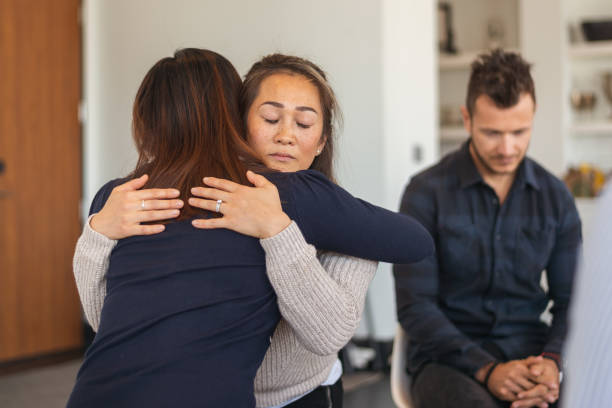 istock Two women hug in therapy session 1173939454