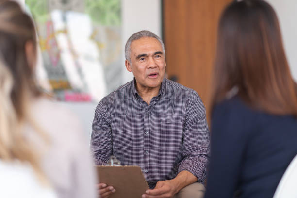 istock Psychologist advises patients in group therapy session 1173939461