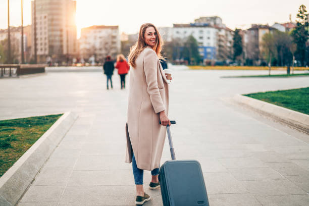 istock Fashionable woman pulling suitcase 1173941512