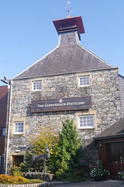 Dufftown, Scotland - May 11 2017: The entrance to the Glenfiddich Scotch whisky distillery with a deer statue in front of it. Glenfiddich means \