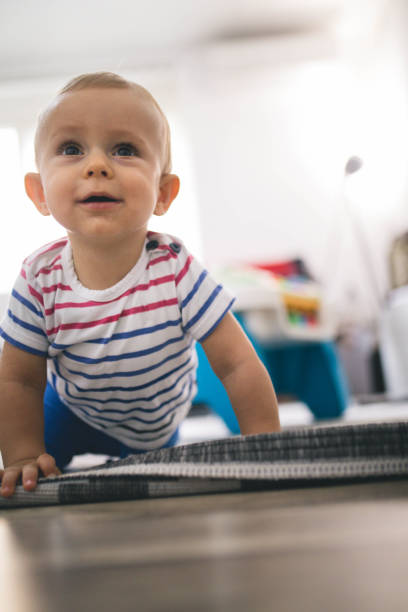 istock Little boy crawling on the floor 1173941884