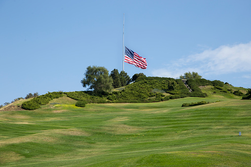 Boise, Idaho, USA - September 11, 2019: An American flag flies at half mast on Patriot Day, atop Simplot hill in Boise, Idaho