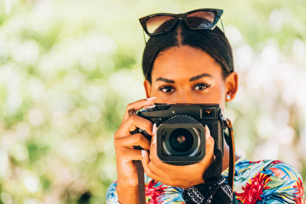 istock Young Black woman with retro digital camera 1173948472