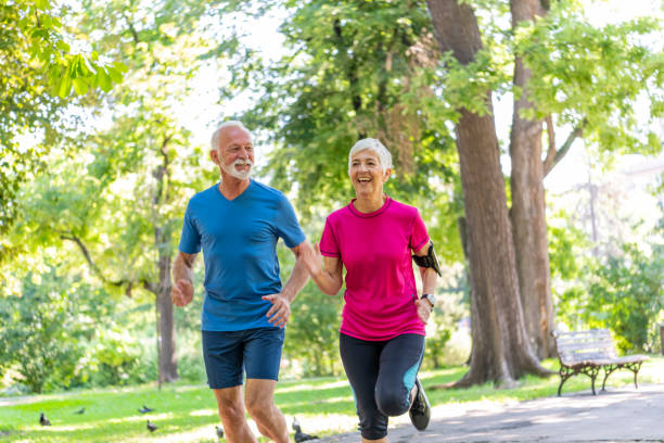 istock Senior Couple is Running in Public Park 1173948936