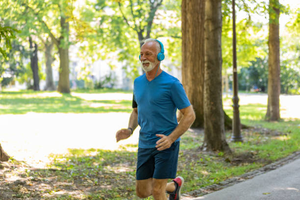 istock Handsome Senior Man is Jogging Outdoors in Nature 1173949629