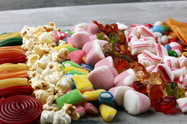 istock Salty snacks. Pretzels, chips, crackers and candy sweets on table 1173950643