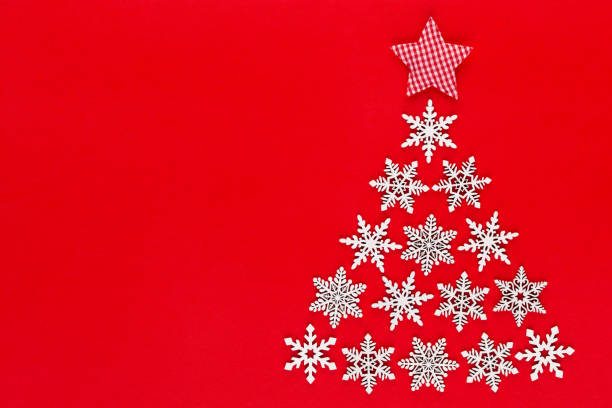 istock White snow flake decoration on red background. Flat lay, top view 1173950696