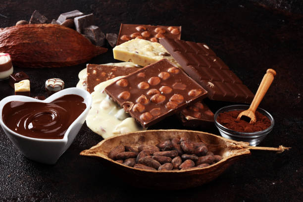 istock Melting chocolate, melted chocolate and chocolate swirl with stack and chips on table 1173951176