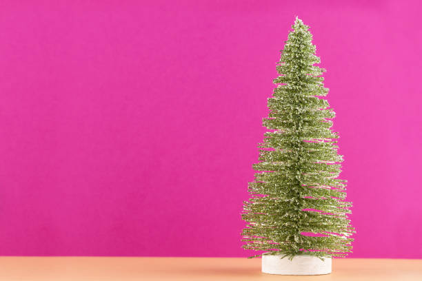 istock Christmas tree on pastel colored background. Christmas or New Year minimal concept. 1173951450