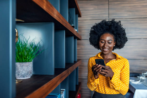 istock Smiling woman entrepreneur using smartphone 1173951551