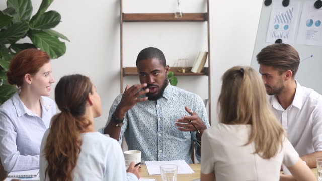 African employee takes part group discussion produce ideas solving problems