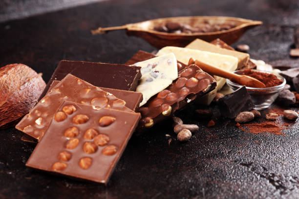 istock Melting chocolate, melted chocolate and chocolate swirl with stack and chips on table 1173952339