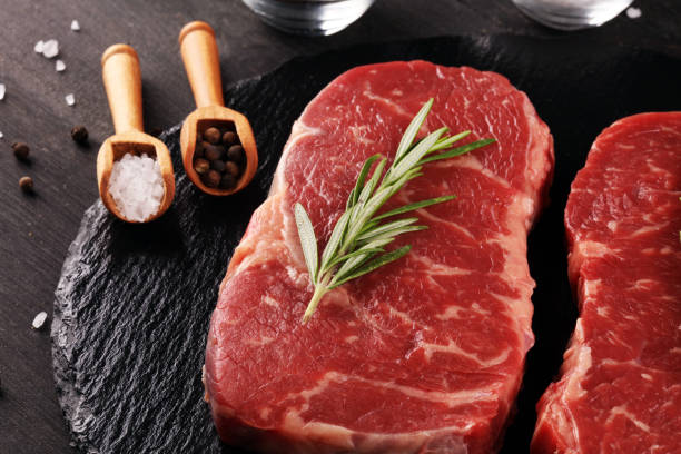 istock Steak raw. Barbecue Rib Eye Steak or rump steak on dark rustic table 1173953694