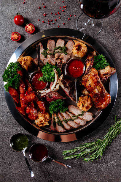 Mixed grilled meat platter. Assorted delicious grilled meat with vegetable.