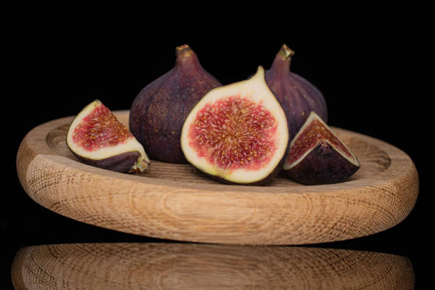 istock Fresh fig fruit isolated on black glass 1173960077