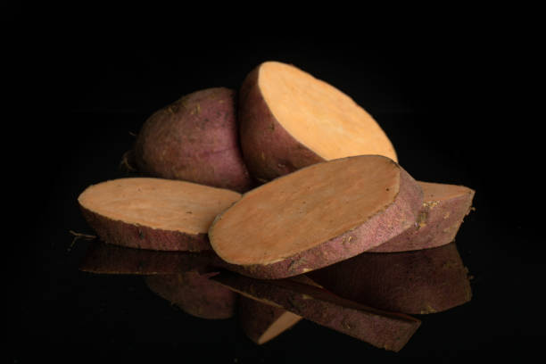 istock Fresh sweet potato isolated on black glass 1173960990