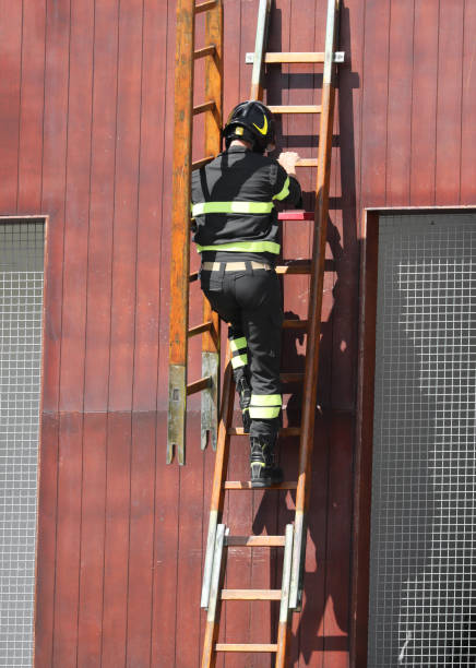 istock fire fighter with a laddder at fire station 1173961560