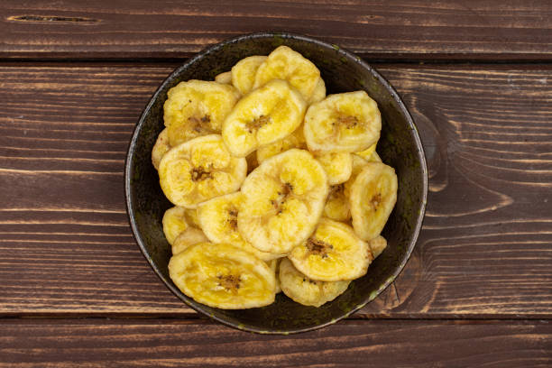 istock Yellow dry banana on brown wood 1173961779