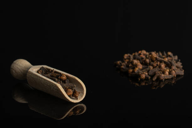 istock Dry brown clove isolated on black glass 1173962208
