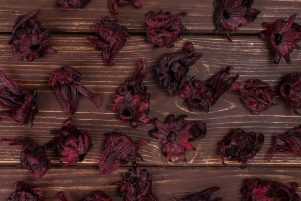 istock Candied hibiscus on brown wood 1173962972