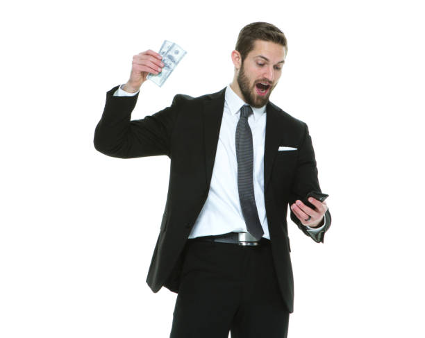 one man only / waist up / front view / looking down of 20-29 years old adult handsome people brown hair / short hair caucasian male / young men businessman / business person standing in front of white background wearing a suit and celebration - thank you excitement waist up horizontal imagens e fotografias de stock