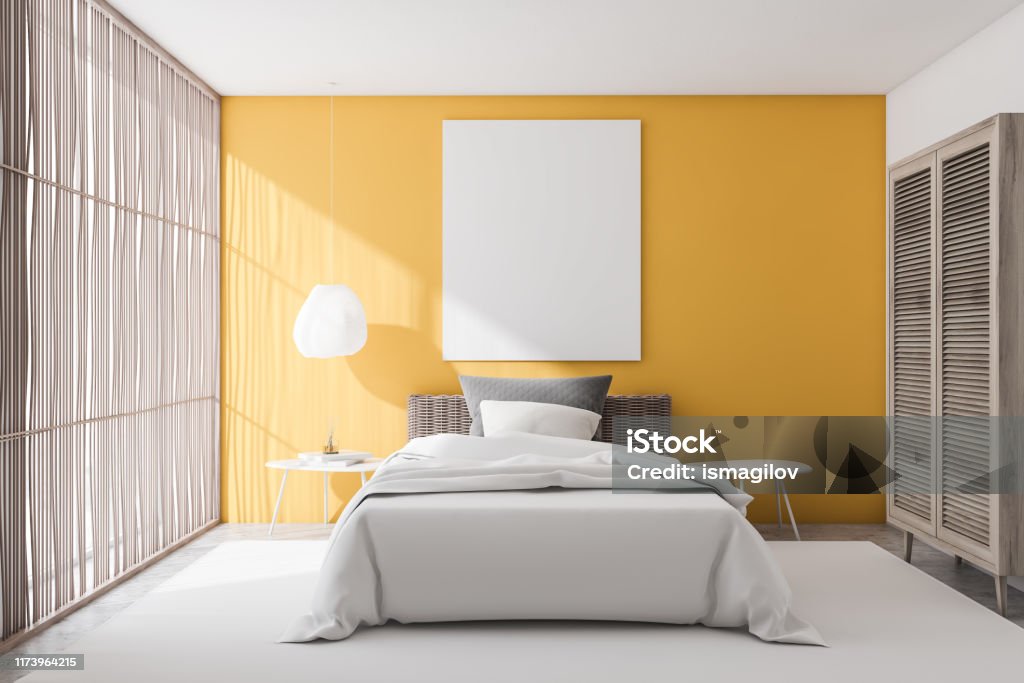 Yellow bedroom interior with poster Interior of stylish bedroom with yellow and white walls, concrete floor with carpet, comfortable bed with gray blanket and two white bedside tables. Vertical mock up poster. 3d rendering Apartment Stock Photo