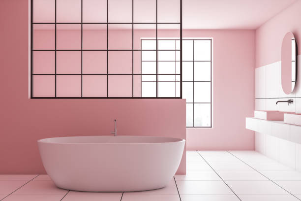istock Pink and white tile bathroom, sink and tub 1173965404