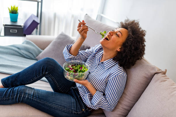 istock Smiling young woman with vegetarian vegetable salad 1173966270