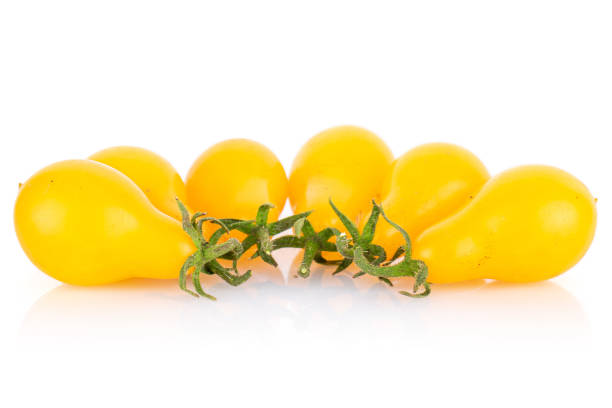 Group of six whole fresh yellow pear tomato isolated on white background