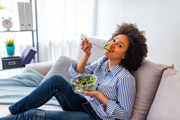 istock Smiling young woman with vegetarian vegetable salad 1173967836