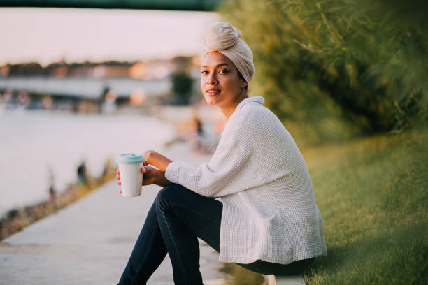 istock Young Muslim girl sitting by a river 1173968276