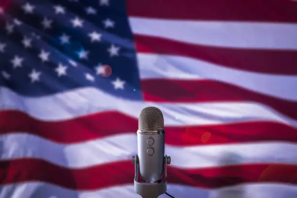 A Microphone In Front Of A USA Flag Ready For A Public Address From The President Or Other Government Figure