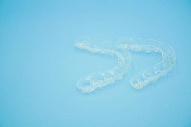 istock beautiful clear retainer teeth that isolated on blue background 1173968892