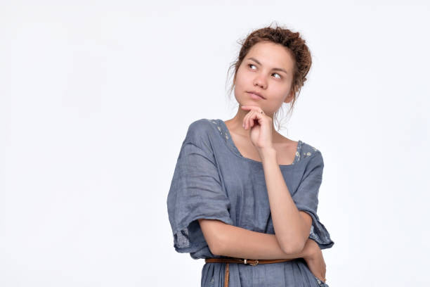 istock Woman with dreadlocks in blue dress thinking looking up imaging her future plans 1173973782