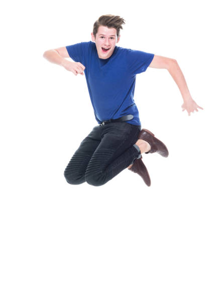 istock Young high school age male jumping 1173976749