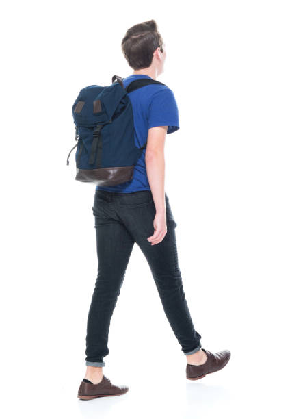 istock Young high school age male student walking 1173976843