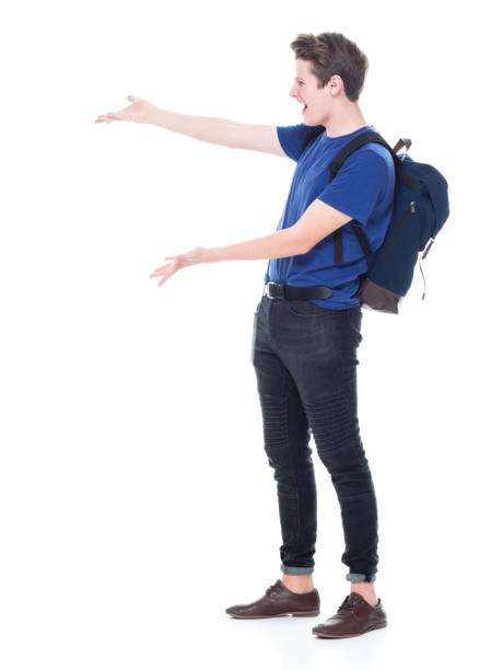istock Young high school age male student is showing to the side 1173977532