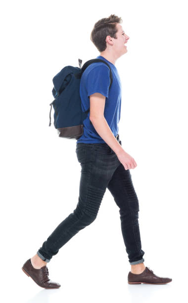 istock Young high school age male student walking 1173977954