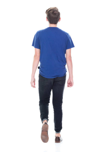istock Young high school age male walking 1173978138